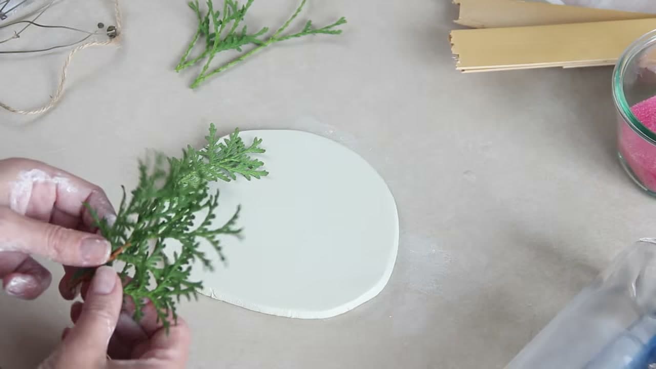 Step 3: Press Evergreen Sprigs Into the Clay - How to Make Air Dry Clay Ornaments for Christmas