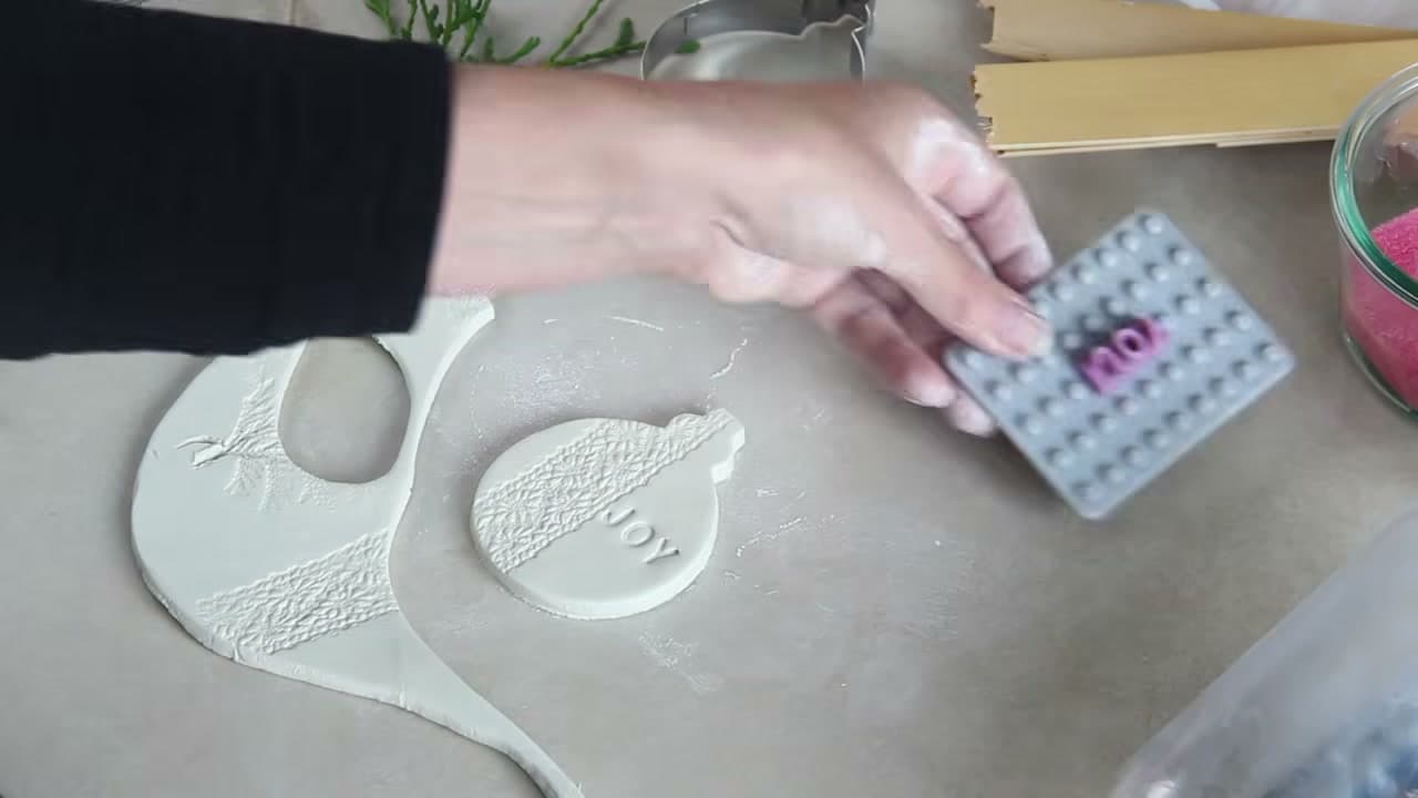 Step 5: Stamp a Word Into the Clay With Letter Stamps - How to Make Air Dry Clay Ornaments for Christmas