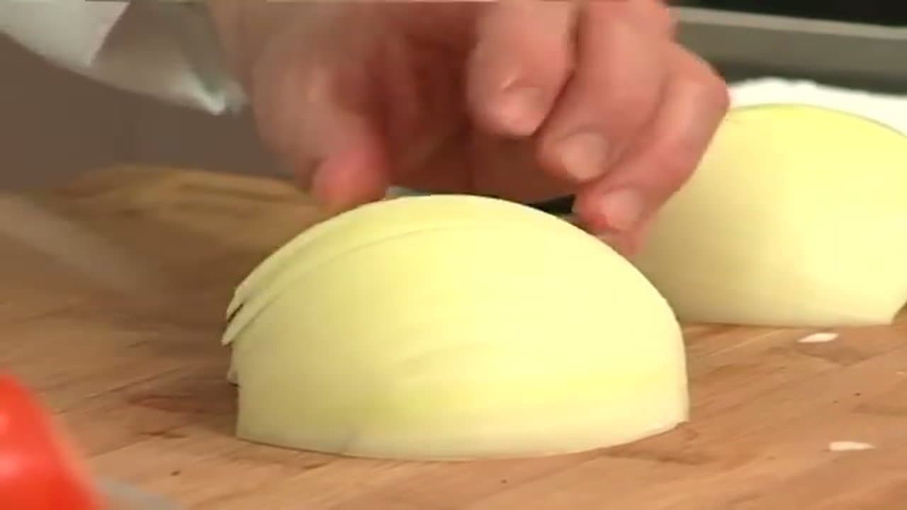 Step 4: Halve the Onion With the Grain