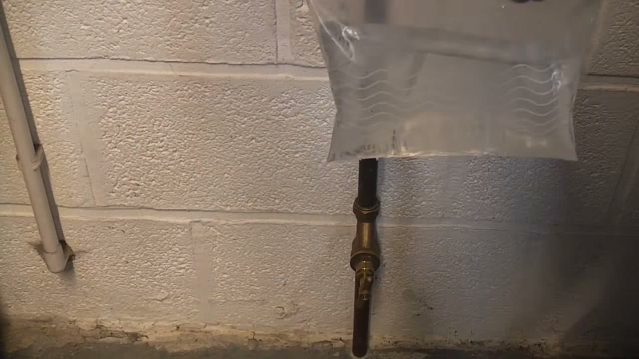 Step 8: Hang a Bag of Hot Water on the Pipe - How to Thaw Frozen Pipes