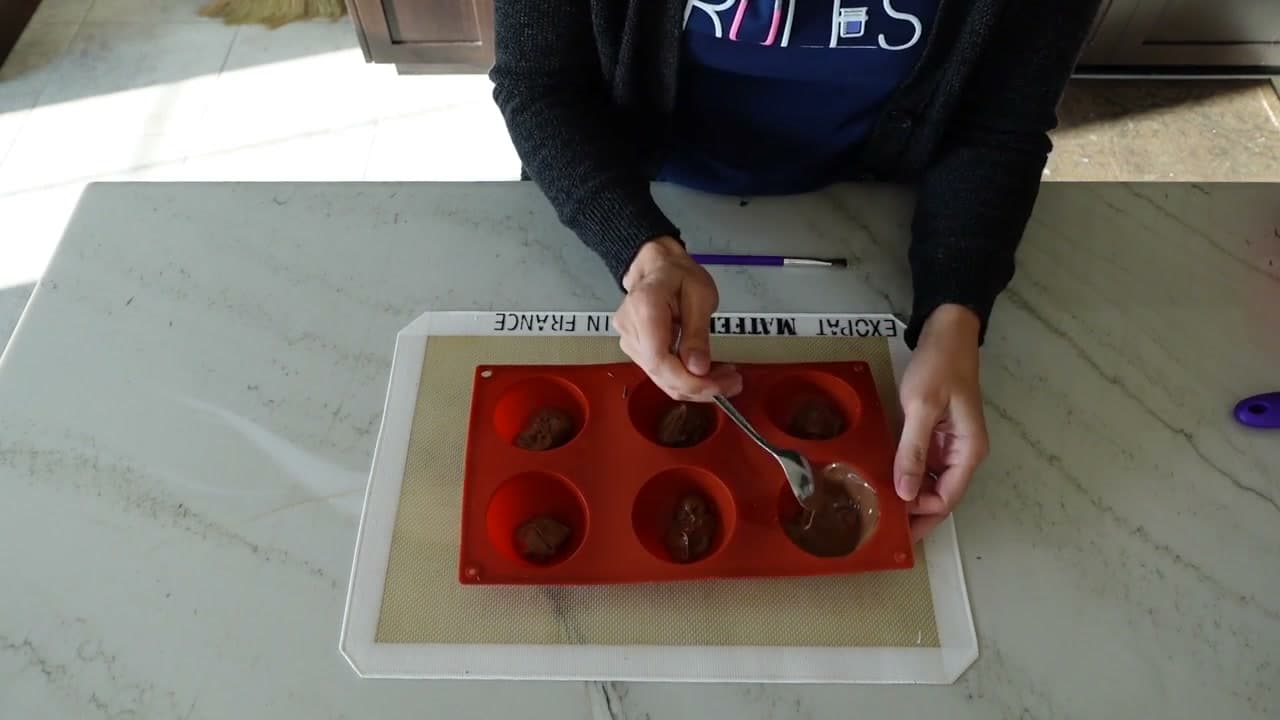 Step 3: Spoon Two Tablespoons of Chocolate into Each Cavity - Hot Cocoa Bomb Recipe: How to Make Them at Home