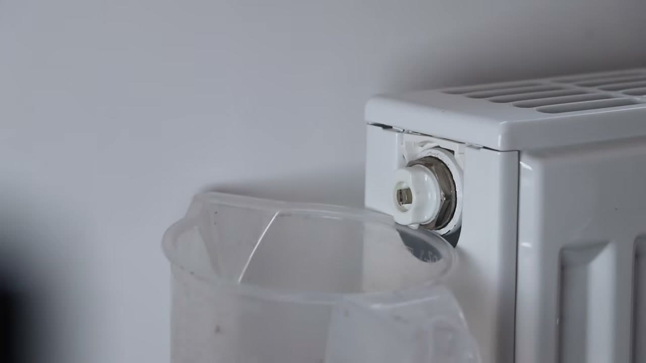 Step 3: Put a Jug Under the Radiator Bleed Valve - How to Bleed a Radiator and Get the Pressure Back Up