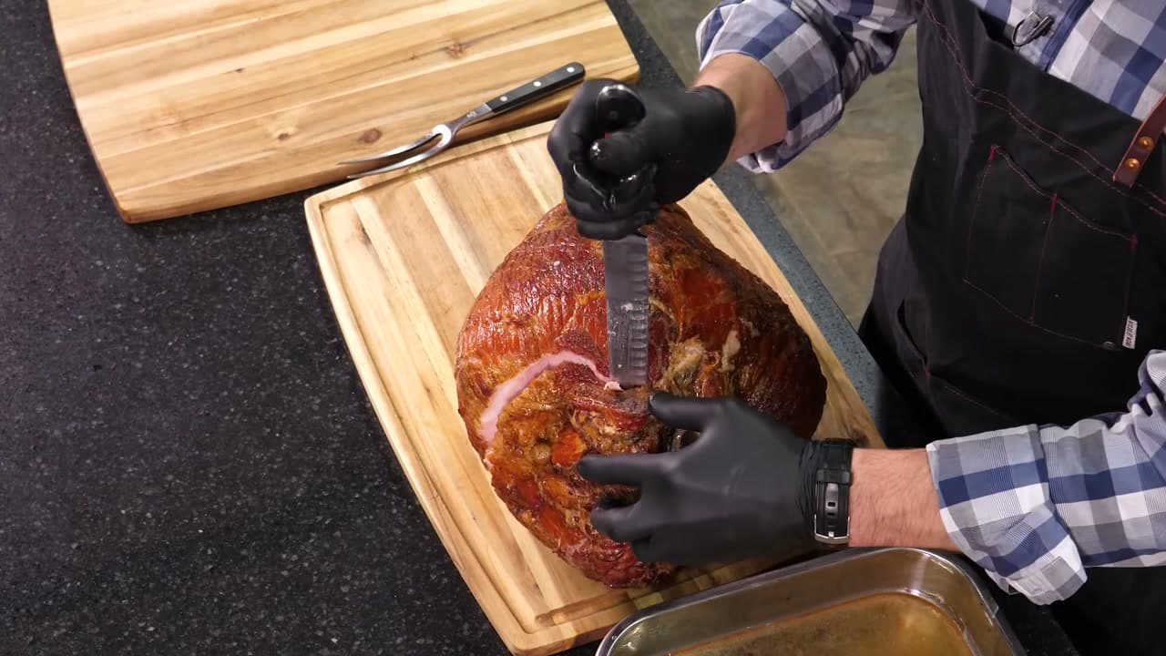 Step 2: Cut Straight Down the Aitch Bone to the Board - How to Carve a Ham