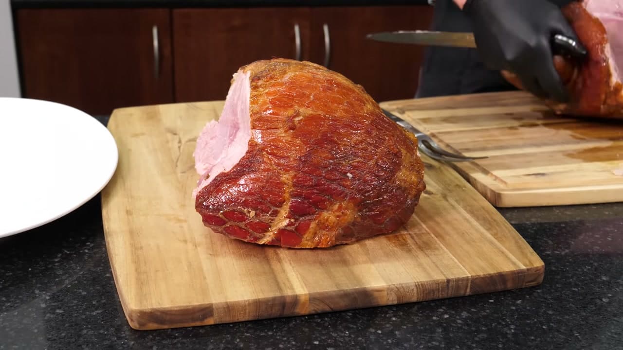 Step 3: Lift the First Boneless Piece Onto a Second Board - How to Carve a Ham
