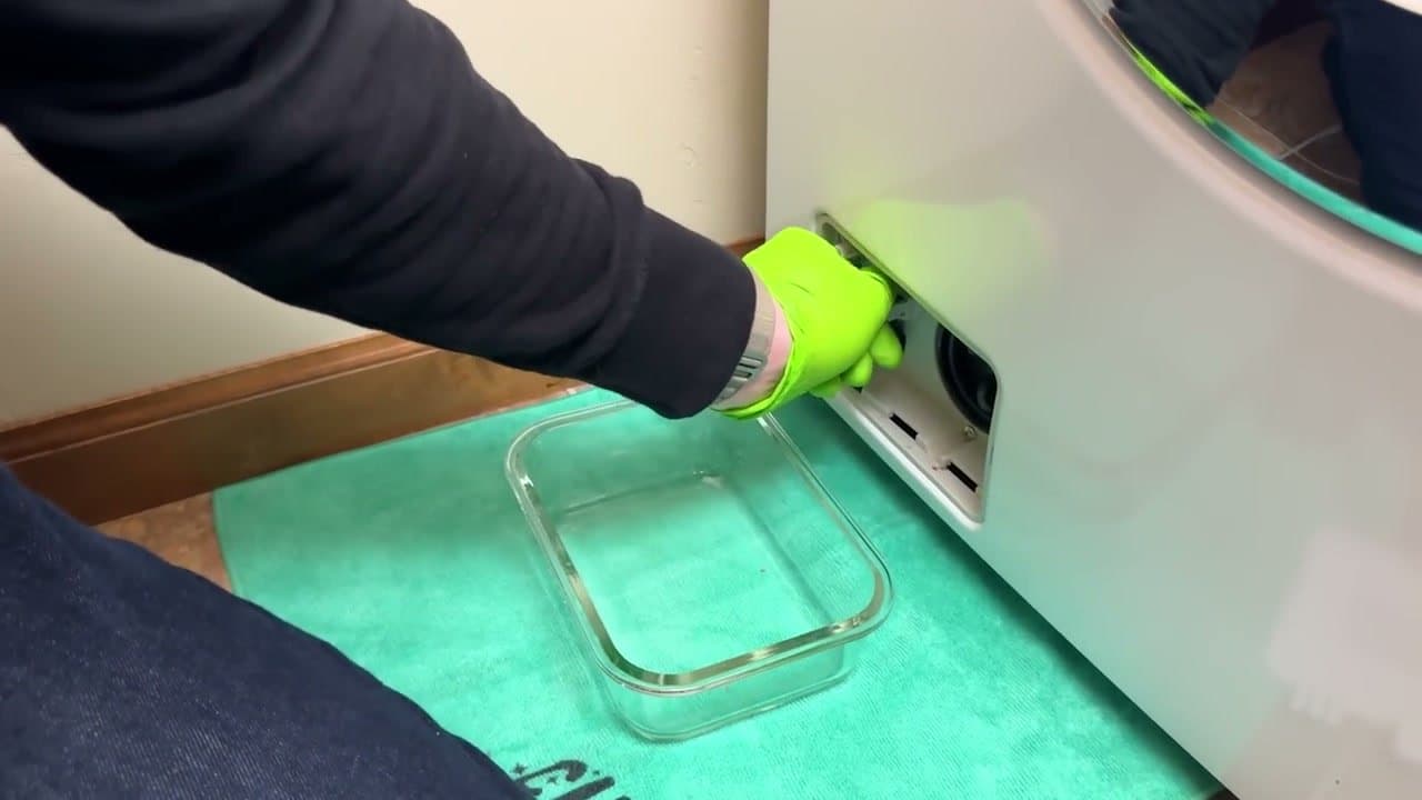 Step 4: Step 4: Open the drain pump trap door and drain the water