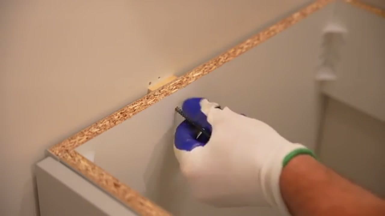 Step 3: Step 3: Set the vanity cabinet and screw it to the wall