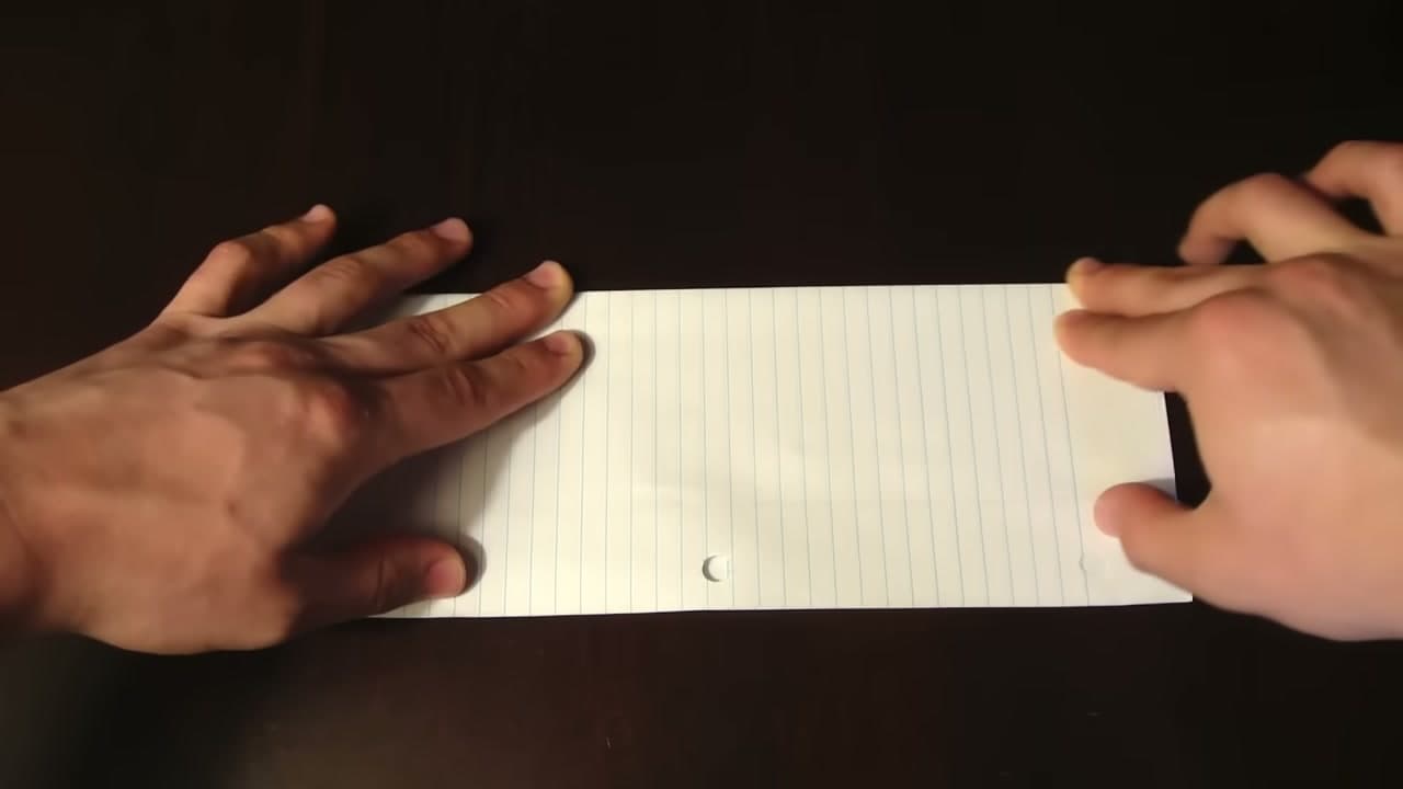 Step 3: Fold the Sheet in Half the Long Way - How to Make a Paper Football (Classic Triangle Fold)