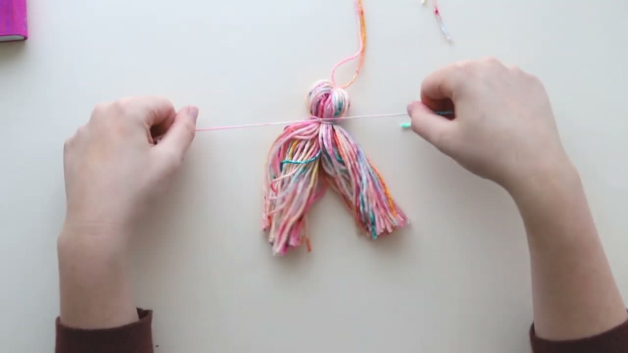 Step 4: Pull a Second Strand Tight Around the Neck of the Tassel - How to Make a Tassel and Attach It to Any Project