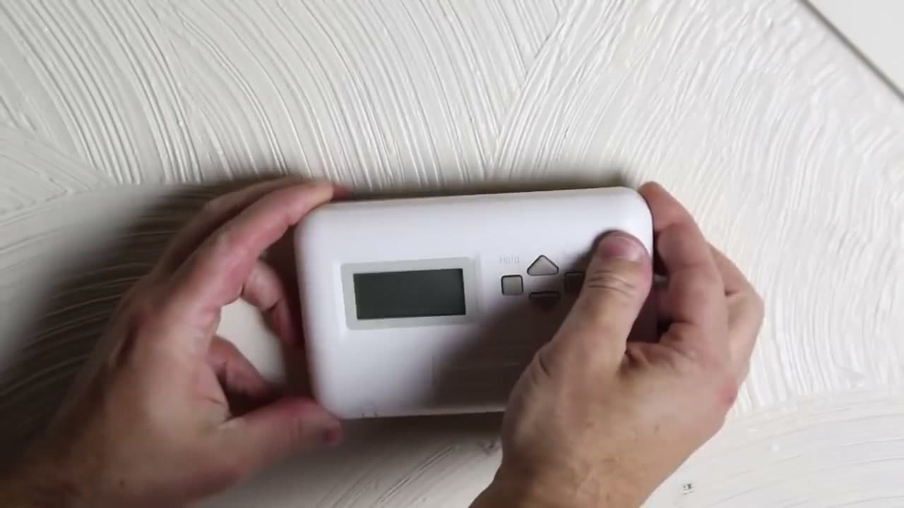 Step 2: Tilt and Pull the Old Thermostat Off Its Base