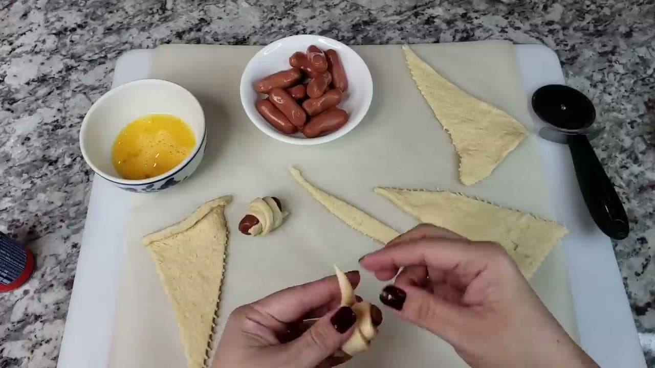 Step 3: Step 3: Wrap each smoky in a dough strip