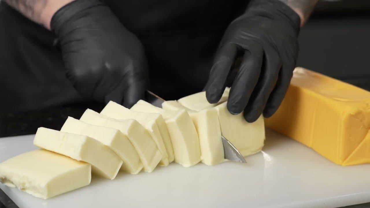Step 2: Step 2: Cube the Velveeta and shred your cheeses